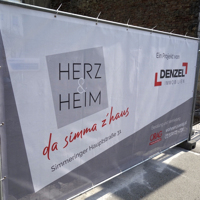 Herz & Heim Bauzauntransparent Logo